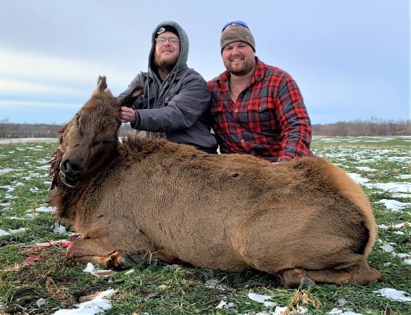 two hunters with elk